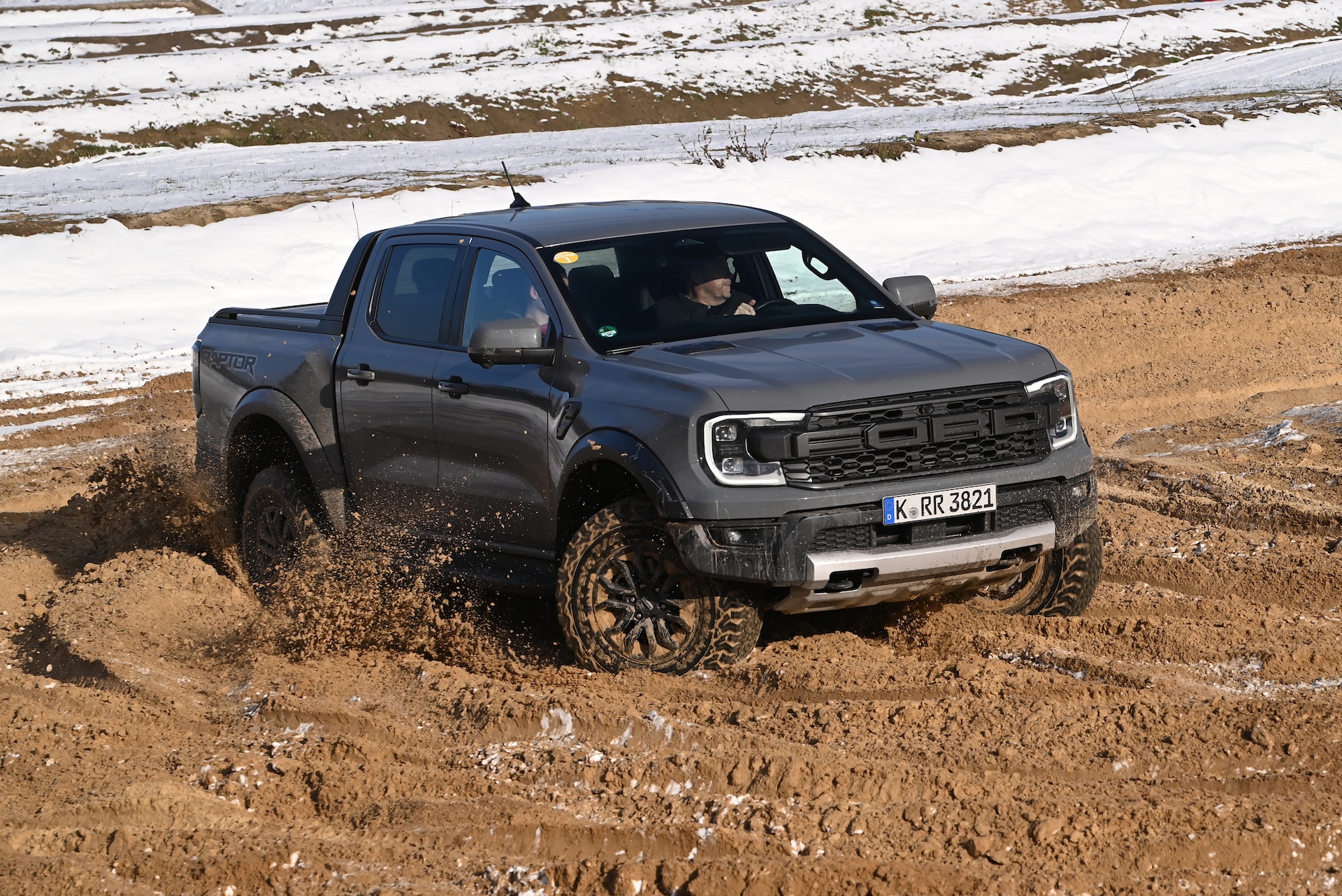Ford Ranger Raptor driving on a muddy road. The Ranger is one of the most popular pickup vehicles in Europe.